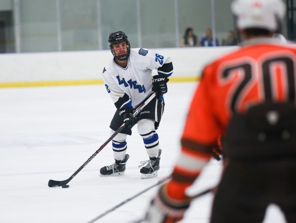 GVL / Kevin Sielaff - Lucas Little (28) passes the puck around during a power play. Grand Valley's Divison II men's hockey squad squares off against Bowling Green University Oct. 16 at Georgetown Ice Arena.