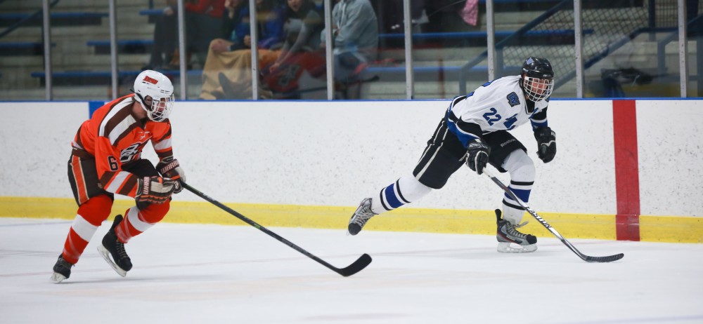 GVL / Kevin Sielaff - Zac Strain (22) pushes the puck up ice on a break away. Grand Valley's Divison II men's hockey squad squares off against Bowling Green University Oct. 16 at Georgetown Ice Arena.