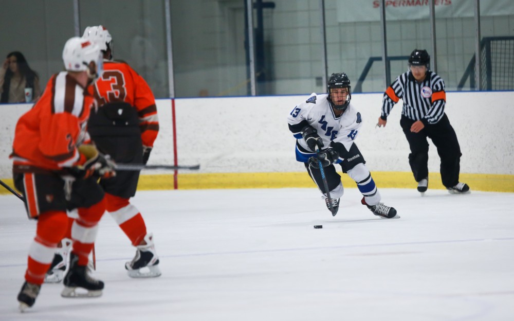 GVL / Kevin Sielaff - Tony Russo (13) moves the puck up ice. Grand Valley's Divison II men's hockey squad squares off against Bowling Green University Oct. 16 at Georgetown Ice Arena.