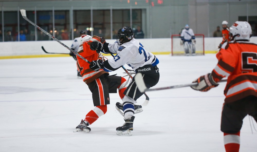 GVL / Kevin Sielaff - Corbin Rainey (27) delivers a strong hit. Grand Valley's Divison II men's hockey squad squares off against Bowling Green University Oct. 16 at Georgetown Ice Arena.