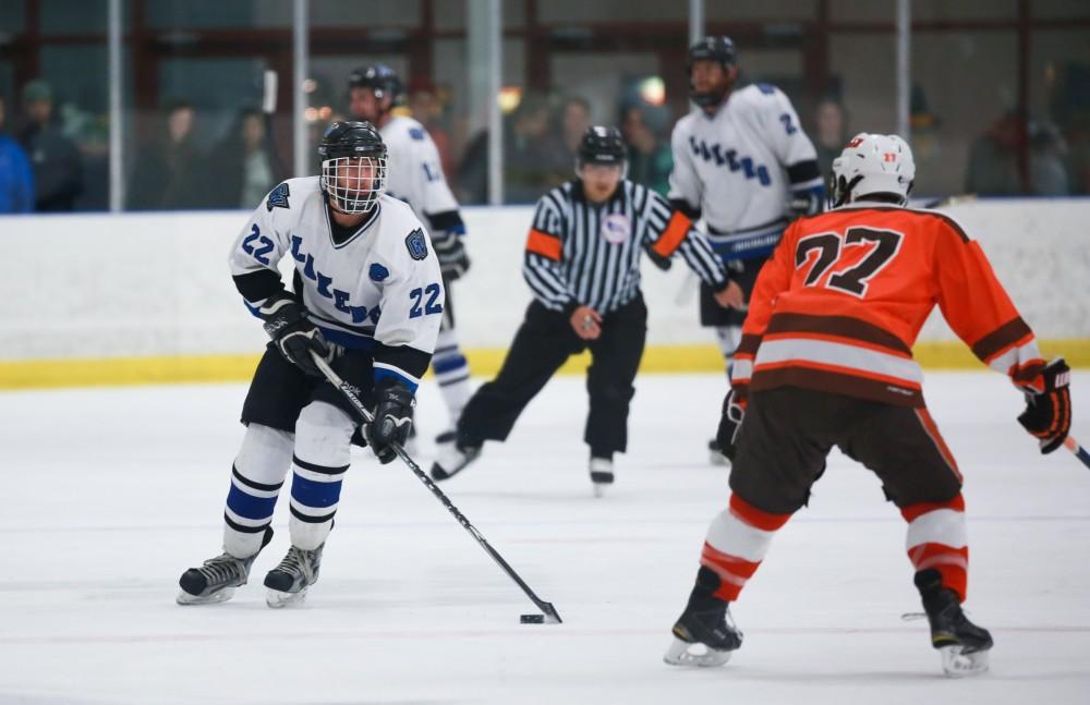 GVL / Kevin Sielaff - Zac Strain (22) pushes the puck up ice. Grand Valley's Divison II men's hockey squad squares off against Bowling Green University Oct. 16 at Georgetown Ice Arena.