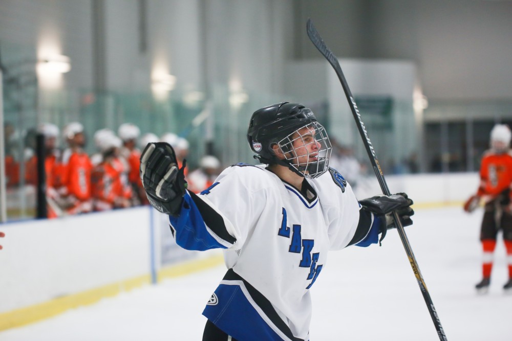 GVL / Kevin Sielaff - Tom Lusynski (4) celebrates a goal scored. Grand Valley's Divison II men's hockey squad squares off against Bowling Green University Oct. 16 at Georgetown Ice Arena.