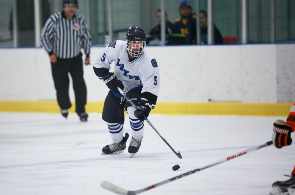 GVL / Kevin Sielaff - Mark Janiga (5) skates the puck toward the net. Grand Valley's Divison II men's hockey squad squares off against Bowling Green University Oct. 16 at Georgetown Ice Arena.