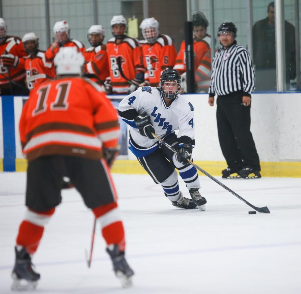 GVL / Kevin Sielaff - Tom Lusynski (4) looks to pass off the puck. Grand Valley's Divison II men's hockey squad squares off against Bowling Green University Oct. 16 at Georgetown Ice Arena.