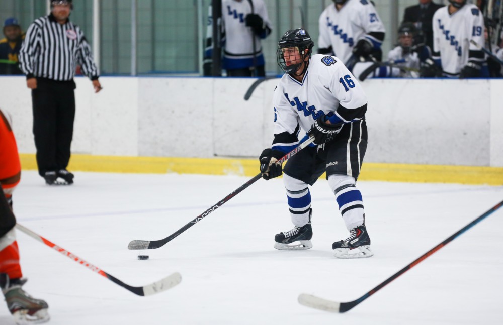 GVL / Kevin Sielaff - Michael Bishop (16) skates with the puck. Grand Valley's Divison II men's hockey squad squares off against Bowling Green University Oct. 16 at Georgetown Ice Arena.