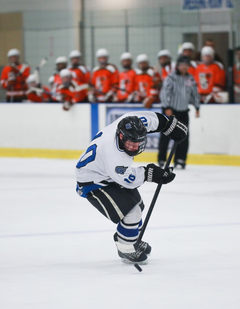 GVL / Kevin Sielaff - Mitch Claggett (10) juggles with the puck before scoring a goal. Grand Valley's Divison II men's hockey squad squares off against Bowling Green University Oct. 16 at Georgetown Ice Arena.