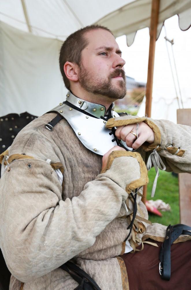 GVL / Kevin Sielaff 
Sir Oron Von Kellsum removes his neck guard. The annual Renaissance fair takes place Oct. 3-4 outside of the Kirkhoff Center in Allendale. 