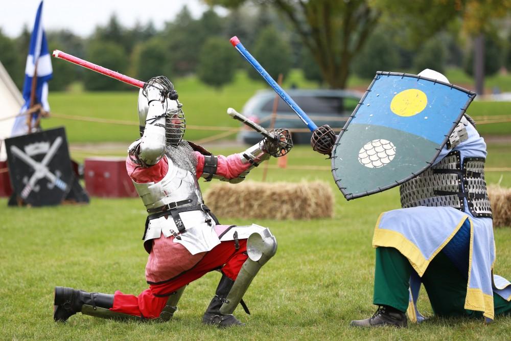 GVL / Kevin Sielaff    
Matt Kruchowski winds up to strike Dan Peacock as they battle during the Renaissance fair. The annual Renaissance fair takes place Oct. 3-4 outside of the Kirkhoff Center in Allendale. 