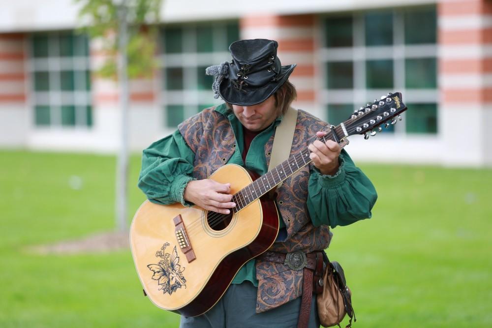 GVL / Kevin Sielaff      
Robyn the Bard plays his guitar in front of those gathered at the Renaissance festival. The annual Renaissance fair takes place Oct. 3-4 outside of the Kirkhoff Center in Allendale. 