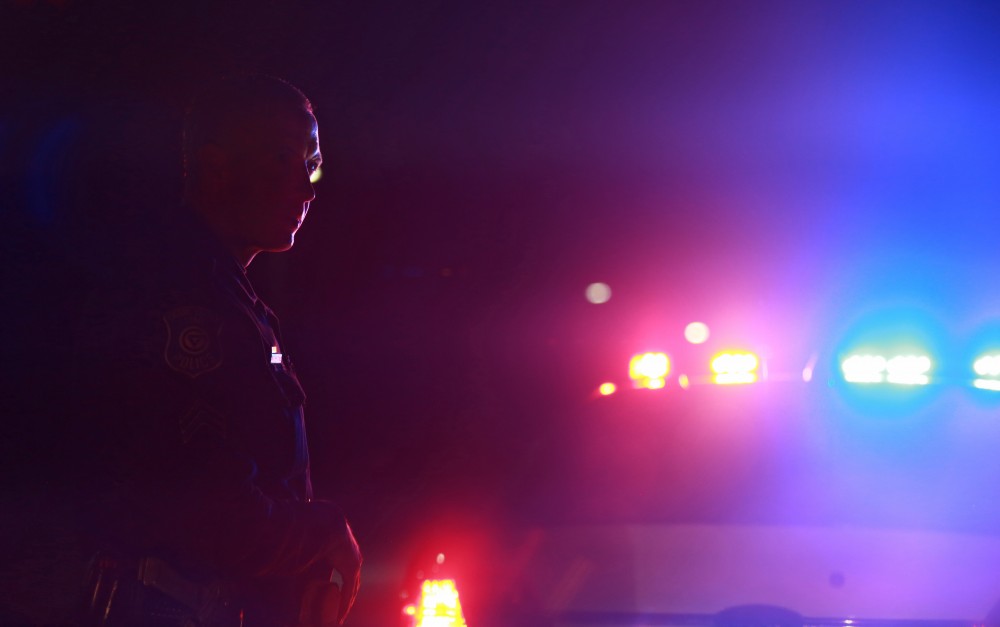 GVL / Kevin Sielaff - Sgt. Jeff Stoll assists his fellow officers as they check the well-being of a male subject alongside West Campus Drive on Oct. 25.