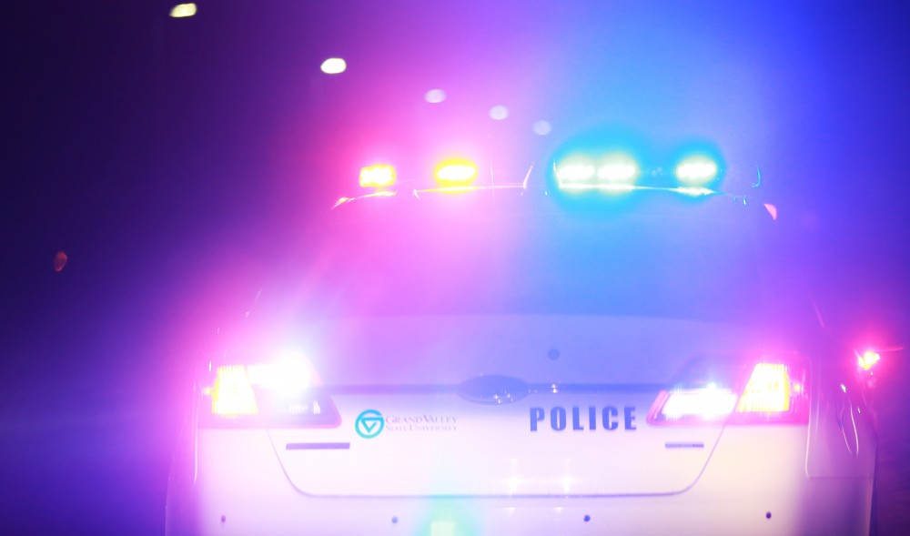 GVL / Kevin Sielaff - Sgt. Jeff Stoll assists his fellow officers as they check the well-being of a male subject alongside West Campus Drive on Oct. 25.