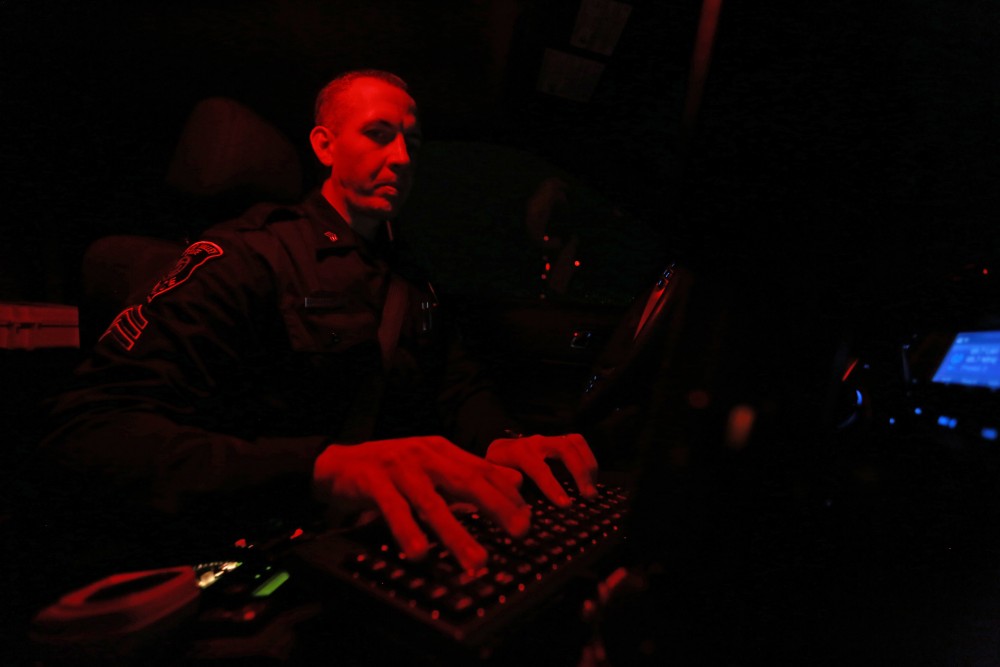 GVL / Kevin Sielaff - Sgt. Jeff Stoll inputs a report into his computer alongside West Campus Drive on Oct. 25.