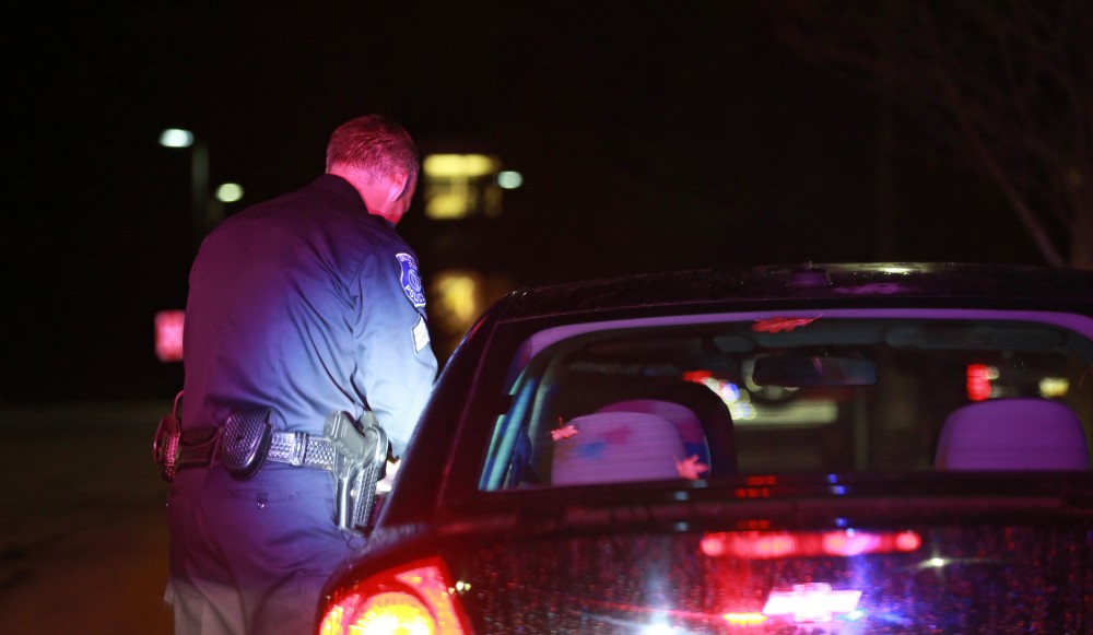 GVL / Kevin Sielaff - Sgt. Jeff Stoll conducts a routine traffic stop near parking lot C on Oct. 25.