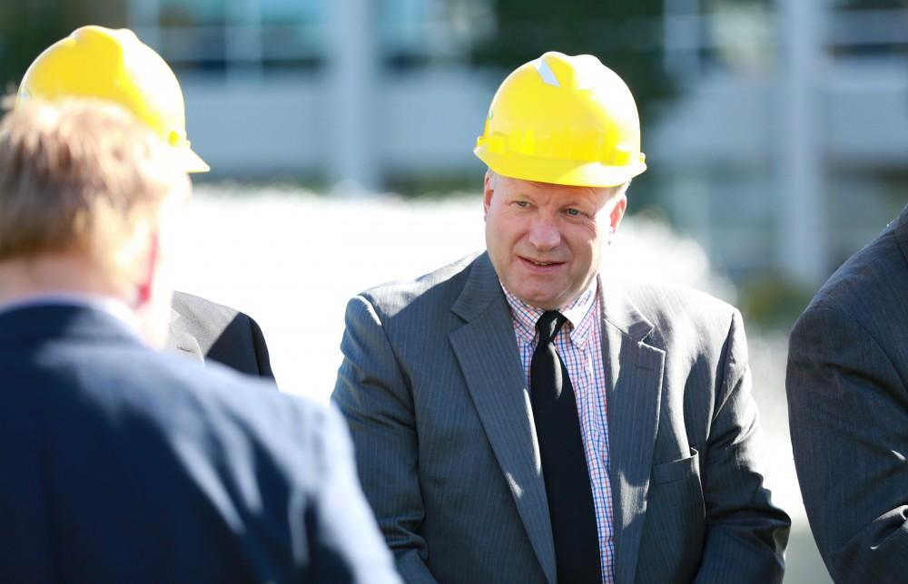 GVL / Kevin Sielaff - John Quackenbush, chairman of the Michigan Public Service Commission, participates in the ground breaking. Officials break ground on Grand Valley's solar garden Oct. 2 in Allendale. By next spring, 17 acres of land near 48th avenue will be generating 3 megawatts of electricity for the community.