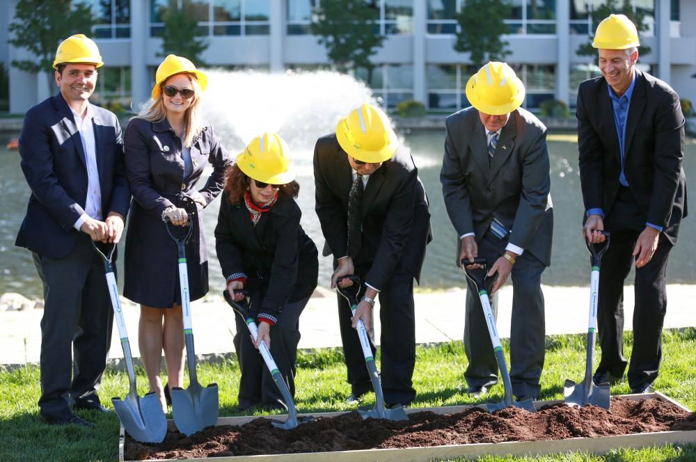 GVL / Kevin Sielaff - Officials break ground on Grand Valley's solar garden Oct. 2 in Allendale. By next spring, 17 acres of land near 48th avenue will be generating 3 megawatts of electricity for the community.