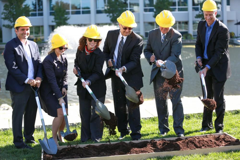 GVL / Kevin Sielaff - Officials break ground on Grand Valley's solar garden Oct. 2 in Allendale. By next spring, 17 acres of land near 48th avenue will be generating 3 megawatts of electricity for the community.