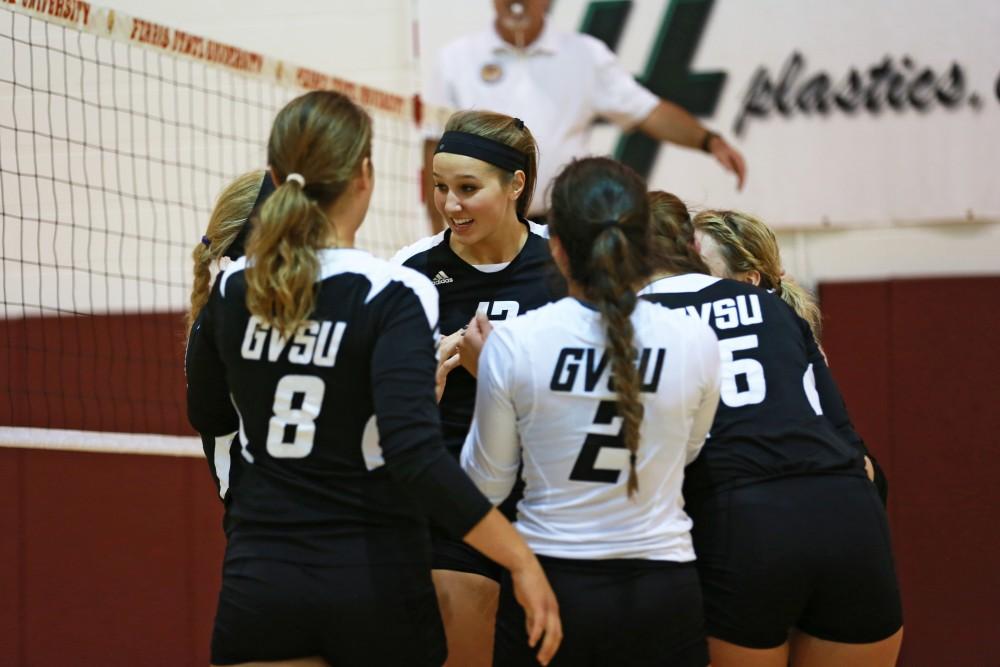 GVL / Kevin Sielaff
Jillian Butsavich (12) huddles with her team. The Lakers fall to the Bulldogs at Ferris State University Sept. 29 by a margin of 3-1. 