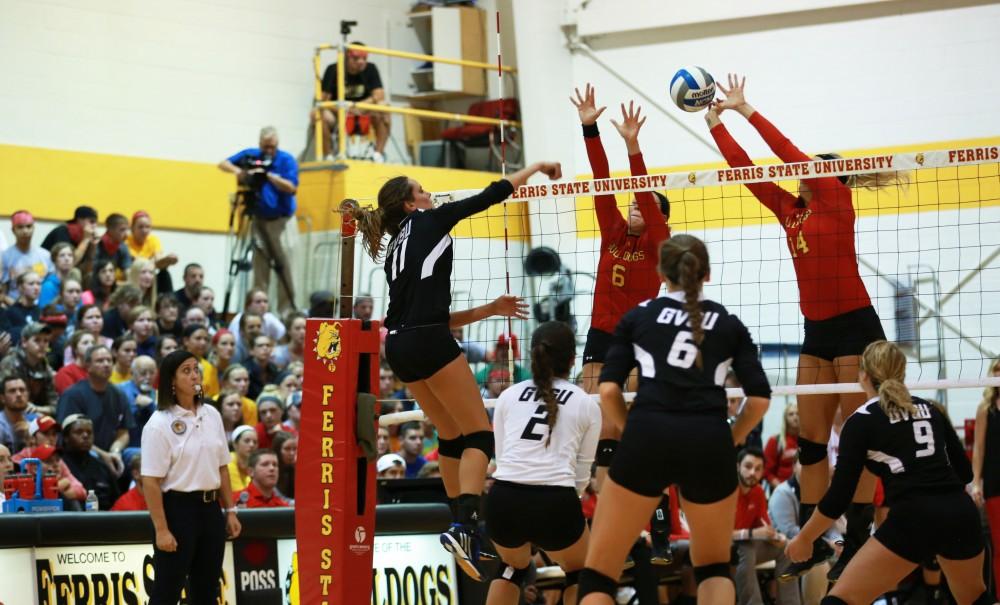 GVL / Kevin Sielaff
Kourtney Wolter (11) attempts to spike the ball past Ferris' defense. The Lakers fall to the Bulldogs at Ferris State University Sept. 29 by a margin of 3-1. 