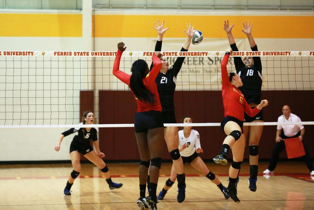 GVL / Kevin Sielaff
Ferris' Stephanie Sikorski (6) sneaks the ball between Staci Brower (21) and Shannon Winicki (18) of Grand Valley. The Lakers fall to the Bulldogs at Ferris State University Sept. 29 by a margin of 3-1. 