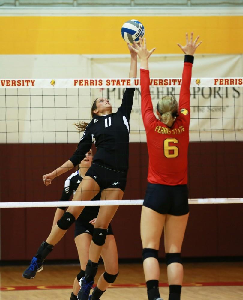 GVL / Kevin Sielaff
Kourtny Wolters (11) attempts to tip the ball over Ferris' defender. The Lakers fall to the Bulldogs at Ferris State University Sept. 29 by a margin of 3-1. 