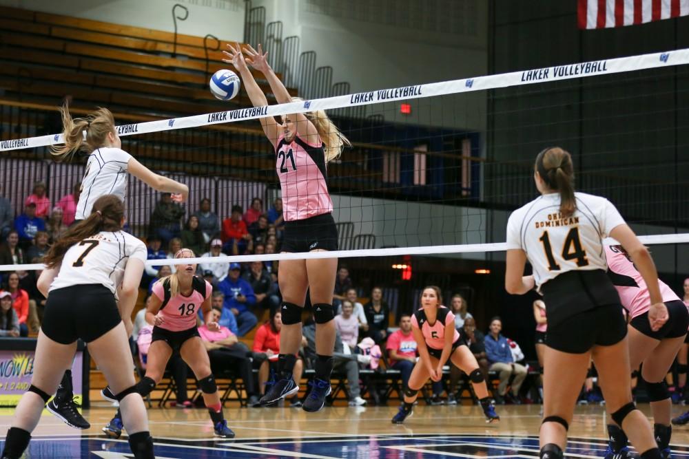 GVL / Kevin Sielaff - Staci Brower (21) attemps to block an incoming spike. Grand Valley squares off against Ohio Dominican and claims the victory with a final score of 3-1.