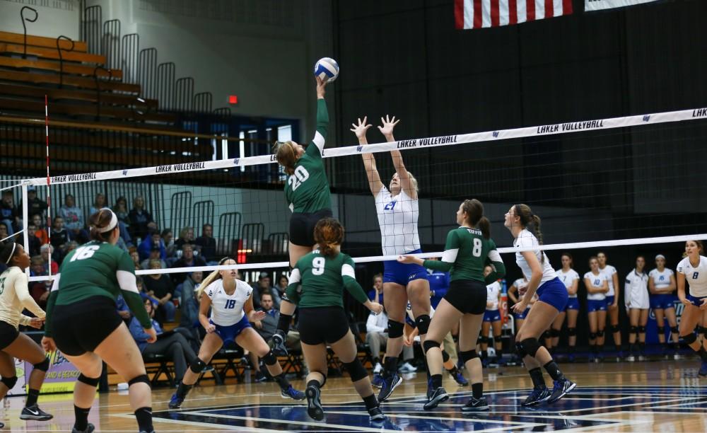 GVL / Kevin Sielaff - Staci Brower (21) rises up to block a tip. Grand Valley sweeps Tiffin Oct. 3 after three sets inside the Fieldhouse Arena in Allendale.