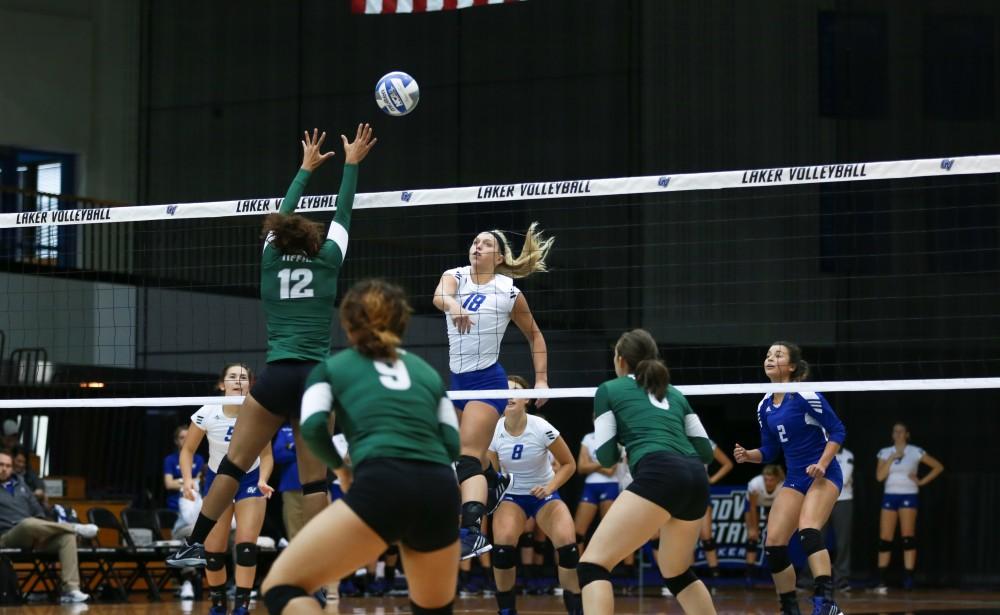 GVL / Kevin Sielaff - Shannon Winicki (18) hits the ball over the hands of a Tiffin defender. Grand Valley sweeps Tiffin Oct. 3 after three sets inside the Fieldhouse Arena in Allendale.