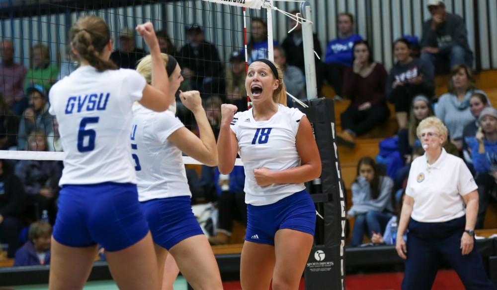 GVL / Kevin Sielaff - Shannon Winicki (18) celebrates with her team after a point scored. Grand Valley sweeps Tiffin Oct. 3 after three sets inside the Fieldhouse Arena in Allendale.