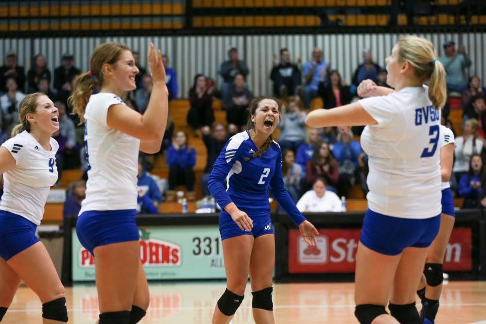 GVL / Kevin Sielaff - Taylor Shomin (2) celebrates with her team after they sweep Tiffin. Grand Valley sweeps Tiffin Oct. 3 after three sets inside the Fieldhouse Arena in Allendale.