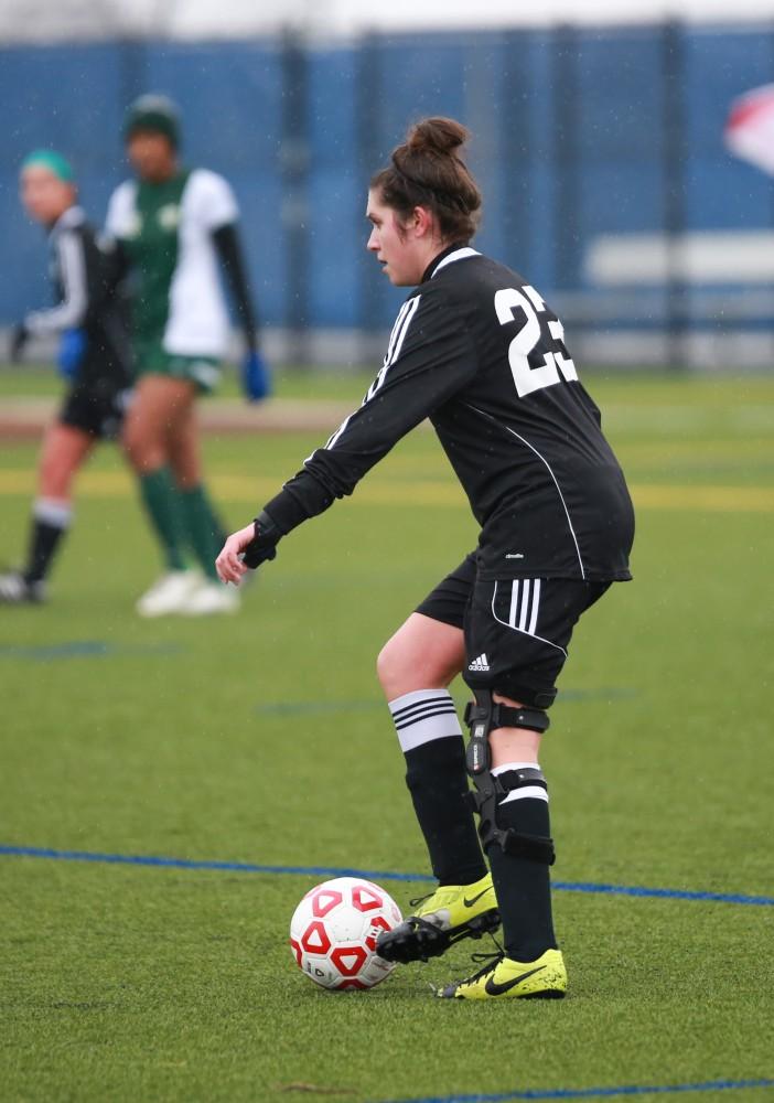 GVL / Kevin Sielaff - Olivia Smith (23) looks to pass the ball down field.  Grand Valley's women's club soccer team squares off against Michigan State on a rainy Oct. 31. The Lakers were defeated, with a final score of 2-0 in favor of Michigan State.