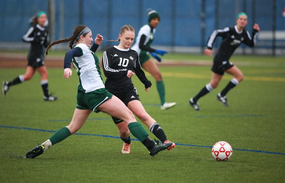 GVL / Kevin Sielaff - Monika Sosnowka (10) fights for the ball in Grand Valley's zone.  Grand Valley's women's club soccer team squares off against Michigan State on a rainy Oct. 31. The Lakers were defeated, with a final score of 2-0 in favor of Michigan State.