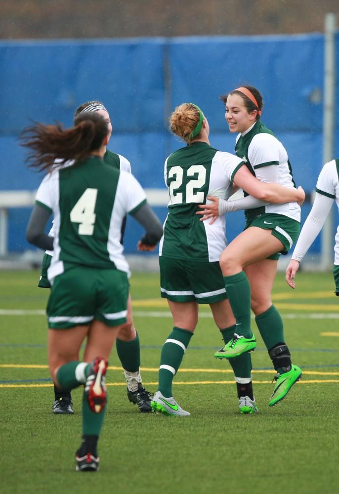 GVL / Kevin Sielaff - Michigan State celebrates their first goal of the game.  Grand Valley's women's club soccer team squares off against Michigan State on a rainy Oct. 31. The Lakers were defeated, with a final score of 2-0 in favor of Michigan State.