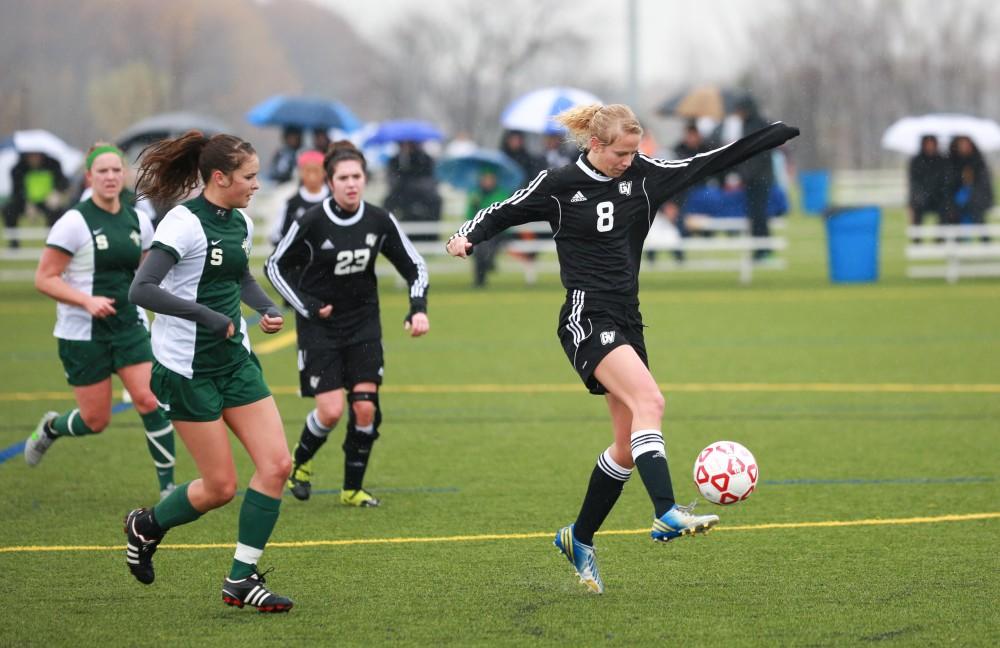 GVL / Kevin Sielaff - Karoline Langheinrich (8) dribbles the ball around midfield.  Grand Valley's women's club soccer team squares off against Michigan State on a rainy Oct. 31. The Lakers were defeated, with a final score of 2-0 in favor of Michigan State.