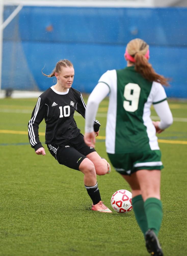 GVL / Kevin Sielaff - Monika Sosnowska (10) passes the ball down field.  Grand Valley's women's club soccer team squares off against Michigan State on a rainy Oct. 31. The Lakers were defeated, with a final score of 2-0 in favor of Michigan State.