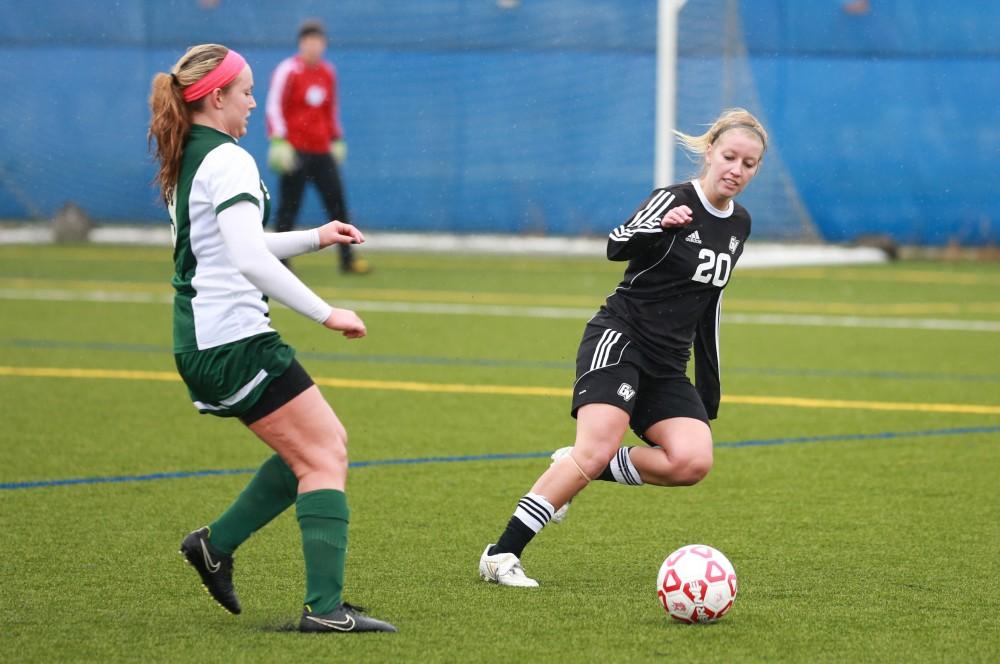 GVL / Kevin Sielaff - Jenny Winters (20) runs to intercept a State pass.  Grand Valley's women's club soccer team squares off against Michigan State on a rainy Oct. 31. The Lakers were defeated, with a final score of 2-0 in favor of Michigan State.