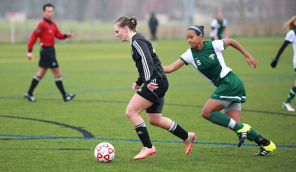 GVL / Kevin Sielaff - Monika Sosnowka (10) sprints toward State's zone.  Grand Valley's women's club soccer team squares off against Michigan State on a rainy Oct. 31. The Lakers were defeated, with a final score of 2-0 in favor of Michigan State.