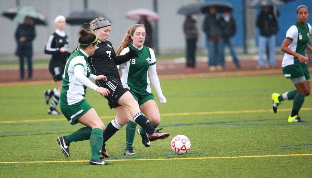 GVL / Kevin Sielaff - Rachel Hoegeman (7) clears the ball.  Grand Valley's women's club soccer team squares off against Michigan State on a rainy Oct. 31. The Lakers were defeated, with a final score of 2-0 in favor of Michigan State.