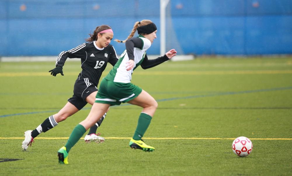 GVL / Kevin Sielaff - Oriana Benincassa (19) sprints to save the ball from going out of bounds.  Grand Valley's women's club soccer team squares off against Michigan State on a rainy Oct. 31. The Lakers were defeated, with a final score of 2-0 in favor of Michigan State.