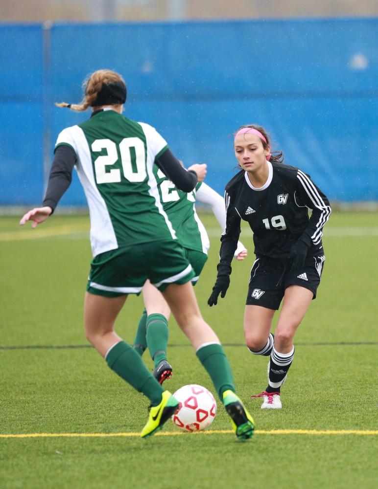 GVL / Kevin Sielaff - Oriana Benincassa (19) positions herself to block on incoming pass into Grand Valley's zone.  Grand Valley's women's club soccer team squares off against Michigan State on a rainy Oct. 31. The Lakers were defeated, with a final score of 2-0 in favor of Michigan State.