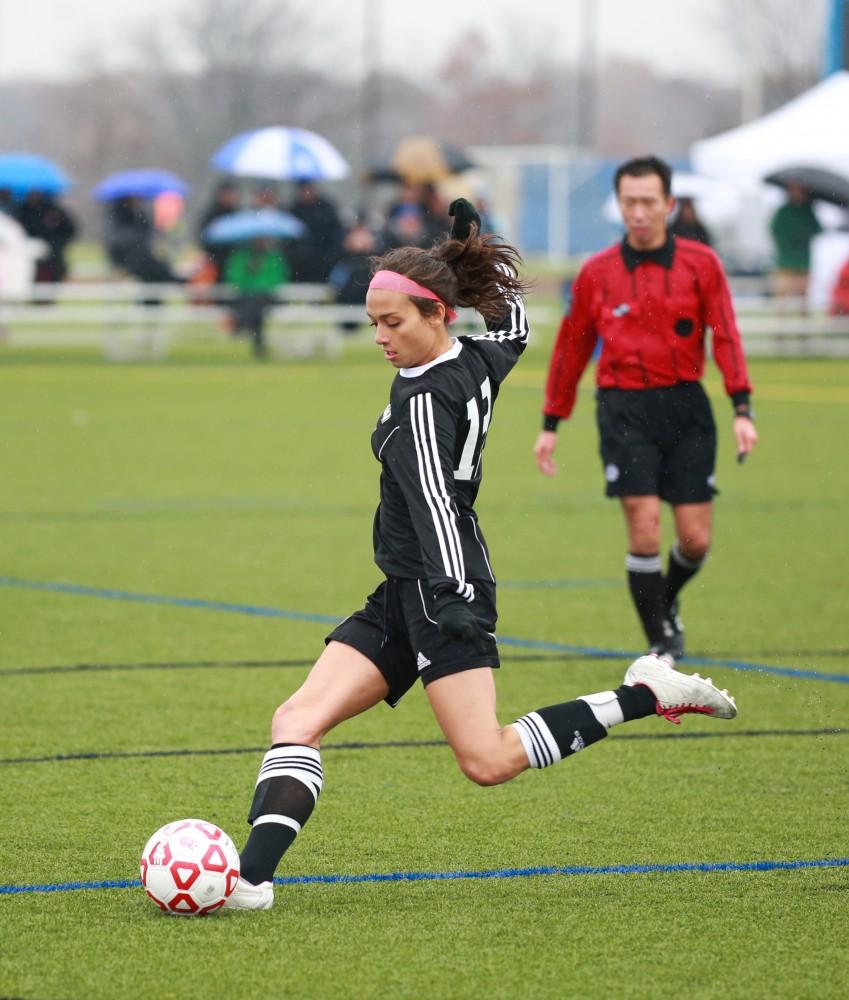 GVL / Kevin Sielaff - Oriana Benincassa (19) tries a shot.  Grand Valley's women's club soccer team squares off against Michigan State on a rainy Oct. 31. The Lakers were defeated, with a final score of 2-0 in favor of Michigan State.