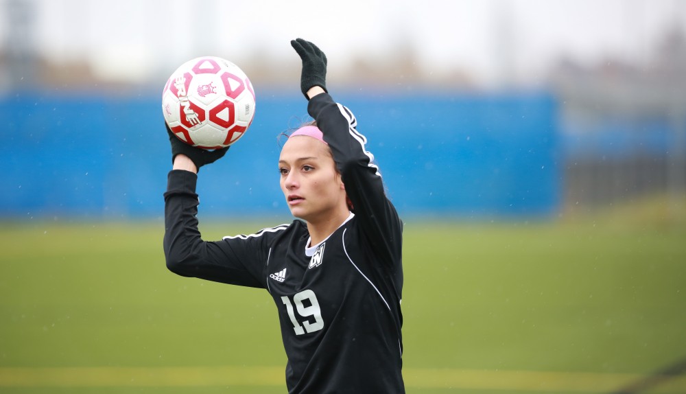 GVL / Kevin Sielaff - Oriana Benincassa (19) throws the ball in bounds.  Grand Valley's women's club soccer team squares off against Michigan State on a rainy Oct. 31. The Lakers were defeated, with a final score of 2-0 in favor of Michigan State.