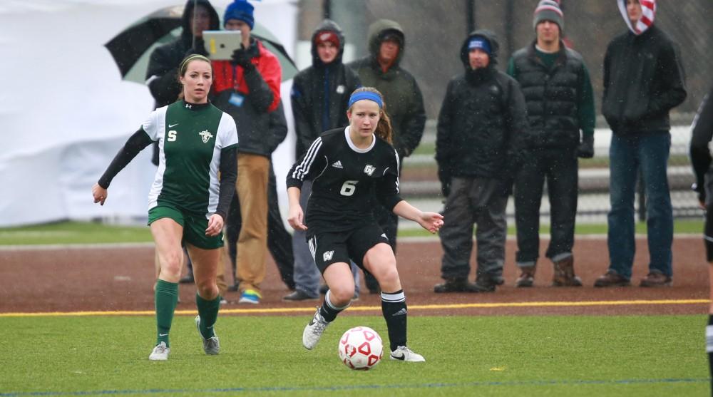 GVL / Kevin Sielaff - Erica Halick (6) passes the ball toward midfield.  Grand Valley's women's club soccer team squares off against Michigan State on a rainy Oct. 31. The Lakers were defeated, with a final score of 2-0 in favor of Michigan State.