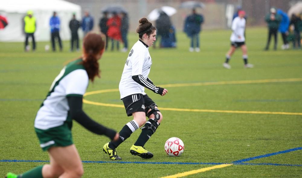 GVL / Kevin Sielaff -  Olivia Smith (23) settles the ball and passes it off. Grand Valley's women's club soccer team squares off against Michigan State on a rainy Oct. 31. The Lakers were defeated, with a final score of 2-0 in favor of Michigan State.