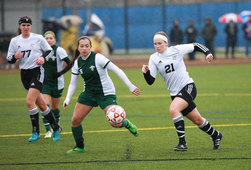 GVL / Kevin Sielaff - Casey Thorn (21) stops the ball from entering Grand Valley's zone.  Grand Valley's women's club soccer team squares off against Michigan State on a rainy Oct. 31. The Lakers were defeated, with a final score of 2-0 in favor of Michigan State.