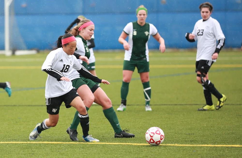 GVL / Kevin Sielaff - Colleen Unsworth (18) fights for the ball.  Grand Valley's women's club soccer team squares off against Michigan State on a rainy Oct. 31. The Lakers were defeated, with a final score of 2-0 in favor of Michigan State.