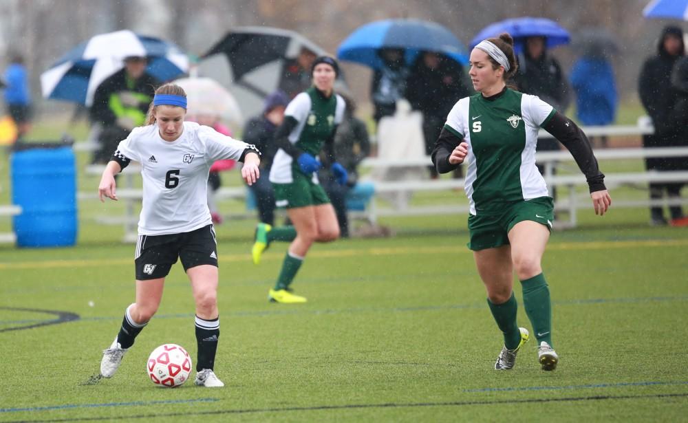 GVL / Kevin Sielaff - Erica Halick (6) pushes the ball up field.  Grand Valley's women's club soccer team squares off against Michigan State on a rainy Oct. 31. The Lakers were defeated, with a final score of 2-0 in favor of Michigan State.