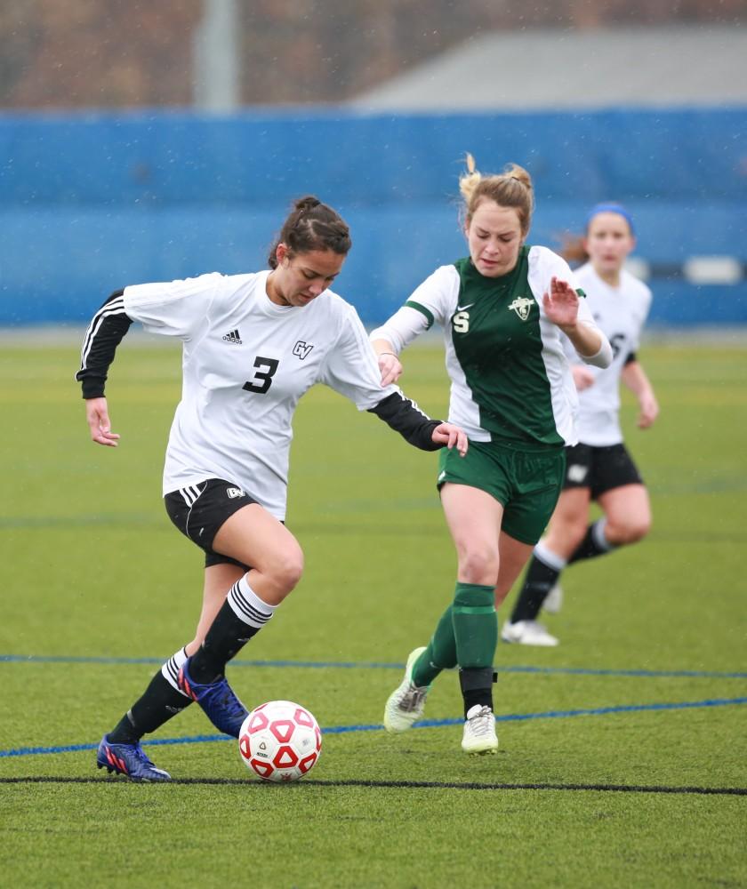 GVL / Kevin Sielaff - Chelsea Fox (3) maintains posession as she travels up field.  Grand Valley's women's club soccer team squares off against Michigan State on a rainy Oct. 31. The Lakers were defeated, with a final score of 2-0 in favor of Michigan State.