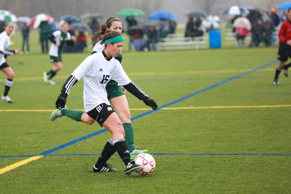 GVL / Kevin Sielaff - Hailey Pellegrom (16) maintains possession as she evades a State attacker.  Grand Valley's women's club soccer team squares off against Michigan State on a rainy Oct. 31. The Lakers were defeated, with a final score of 2-0 in favor of Michigan State.