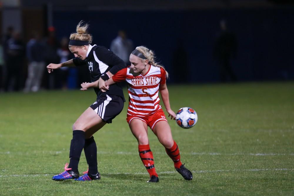 GVL / Kevin Sielaff - Tracey McCoy (24) and Kate Kelly (5) battle near midfield.  The Lakers defeat the Bulldogs with a final score of 2-0 Oct. 30 in Allendale. Grand Valley will advance to the GLIAC tournament starting Nov. 3.