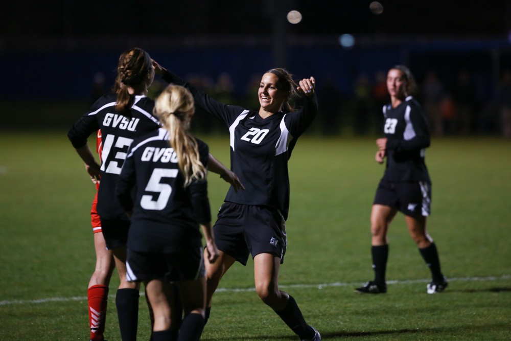 GVL / Kevin Sielaff - Gabriella Mencotti (20) heads the ball into the net and celebrates her goal.  The Lakers defeat the Bulldogs with a final score of 2-0 Oct. 30 in Allendale. Grand Valley will advance to the GLIAC tournament starting Nov. 3.